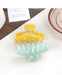 Detail view of large bright yellow and light cyan marbled resin hair claws for women