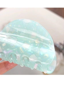 Close-up of mint green marble pattern hair claw clip with acetate texture and polished teeth