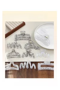 Detail view of assorted geometric lace pattern hair claw clips in acrylic and metal