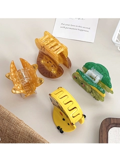 Set of four cute animal-shaped acetate hair claws including lion and giraffe designs