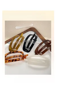 Group shot of five elegant oval hair claw clips in assorted glossy acetate finishes