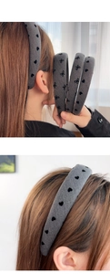 Close-up of padded grey denim headband featuring black heart and bow velvet patterns