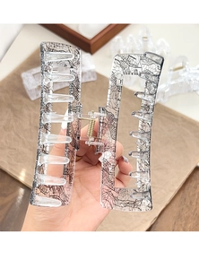 Close-up of lace pattern print on transparent acrylic hair claw clip with golden spring
