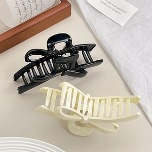 Glossy bow hair claw clips in black and cream white for thick hair styling