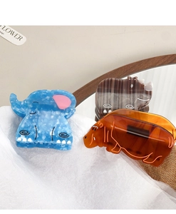 Detailed view of handmade acetate animal claw clips with marble texture for hair styling