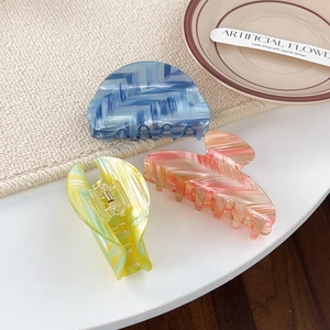 Three-piece large marble texture hair claws in blue, pink, and green with gold springs