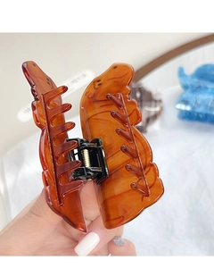 Detail of amber Capybara acrylic hair claw clip with sturdy black metal spring