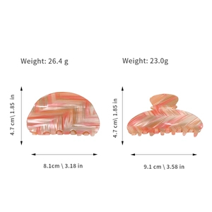 Pink and beige PVC hair claws with weight and size details on white background