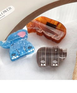 Detailed view of creative hippo and elephant acrylic hair claws with marble textures