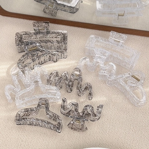 Lace patterned acrylic hair claws in black and white styles for elegant updos