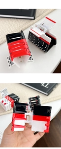 Detail view of acetate playing card pattern hair claws showing texture and spring