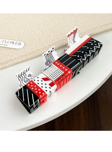 Detailed set of three geometric poker-style hair claws with rhinestones on a mat