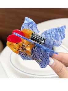 Detailed close-up of goldfish hair claw clip with colorful acetate finish and metal spring