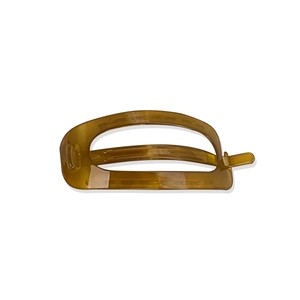 Minimalist amber oval hair clip with smooth resin finish and secure mechanical clasp