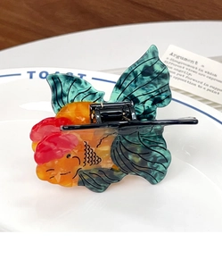 Macro shot of creative goldfish hair claw made of premium colorful acetate material