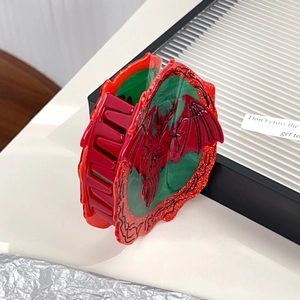 Gothic green hair claw clip with red dragon motifs and tassels for elegant styling