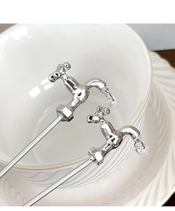 Macro side view of creative silver faucet hairpin with a hanging crystal water drop