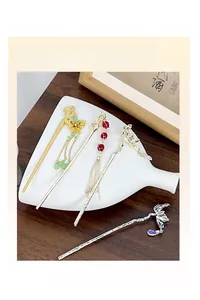 Detail of traditional Chinese hairpins with butterfly flower patterns and long tassels