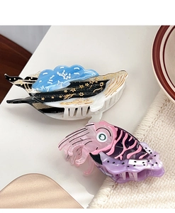 Detail of whale and squid shaped hair claws with intricate acetate marbling and star motifs