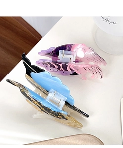 Detail view showing blue and purple gradient acetate hair claws with premium metal springs