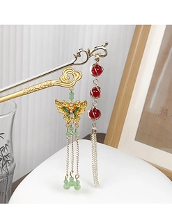 Detailed close-up of golden butterfly tassel hairpin and silver beaded hair stick