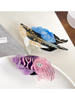 Detail of whale and cutie squid acetate hair claws with artistic ocean patterns and texture