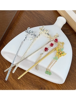 Detailed close-up of Chinese hairpins featuring enamel butterfly and tassel designs