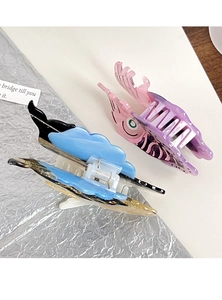 Detail view of large acetate shark hair clips with unique ocean themed whale patterns