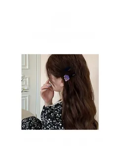 Detail of sweet acetate fruit hair clips showing cherry and grape shapes on long hair