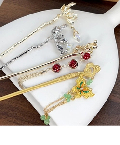 Detailed close-up of four Chinese hairpins with metal tassels and floral butterfly elements