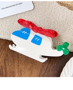 Detail shot of a colorful helicopter hair claw clip with smooth glossy acetate finish