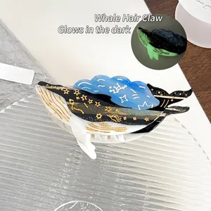 Glow-in-the-dark whale hair claw clip made of acetate with blue and black ocean pattern