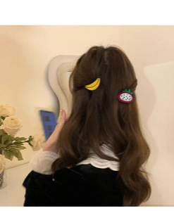 Banana and dragon fruit hair clips worn on hair for a cute aesthetic styling
