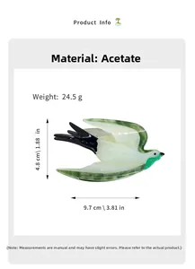 Macro detail of bird-shaped hair claw made of green and cream cellulose acetate material