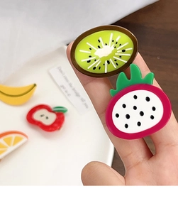 Close-up of cute 3D fruit hair clips featuring kiwi, banana, and apple acetate designs
