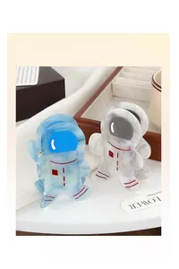 Close-up of cute astronaut acetate hair claws in blue and marble white on a wooden tray