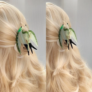 Elegant bird shaped hair claw clip in green and white colors for French style hairstyles