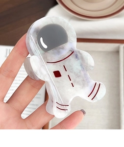 Macro detail of astronaut acetate hair claw clip showing marble texture and pearl finish