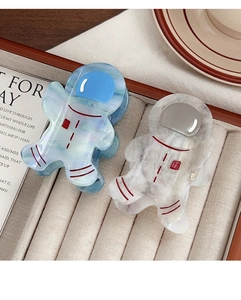 Close-up of cute astronaut hair claws with blue marble and white stone textures