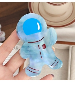 Detail showing the blue marble texture and red accents on the astronaut hair claw
