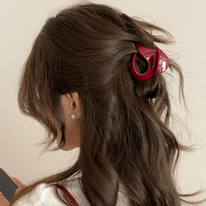 Elegant wine red pumpkin hair claw clip for high ponytail styling on brunette hair