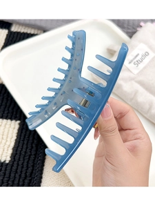 Close-up of translucent blue hair claw clip with strong metal spring for long hair