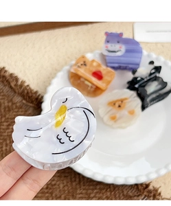 Close-up of cute cartoon animal hair claws in acetate with marble texture finish