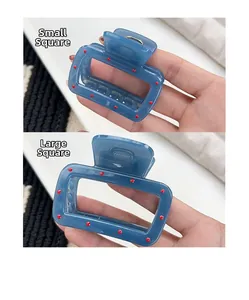 Size comparison of small and large matte blue square hair claws with red dot patterns
