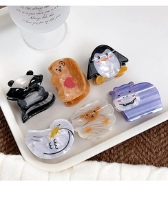 Set of six cartoon animal hair claws with marble texture in a white tray