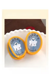 Detail of yellow ghost claw clips with blue marble pattern and Monday text for Halloween