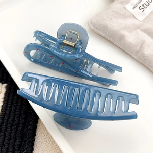 Set of two blue polka dot hair claws in matte translucent finish with red spots