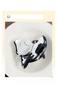 Detail of cute whale and ray hair claw clips in a white ceramic dish accessory display