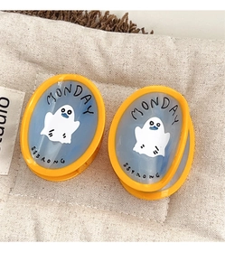 Detail of blue acetate hair clips with yellow frames and cute ghost ghost cartoon design