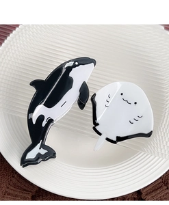 Detail of cute orca and stingray hair claws made of high-quality polished acetate material